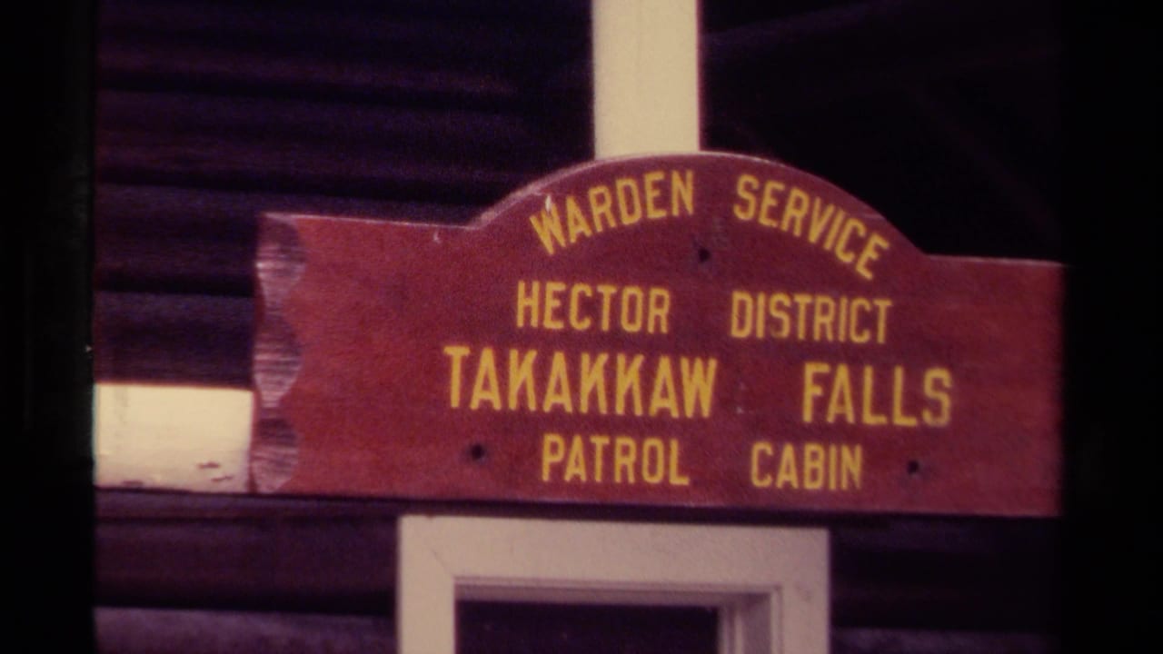 Weathered Takakkaw Falls Patrol Cabin sign on a log building.