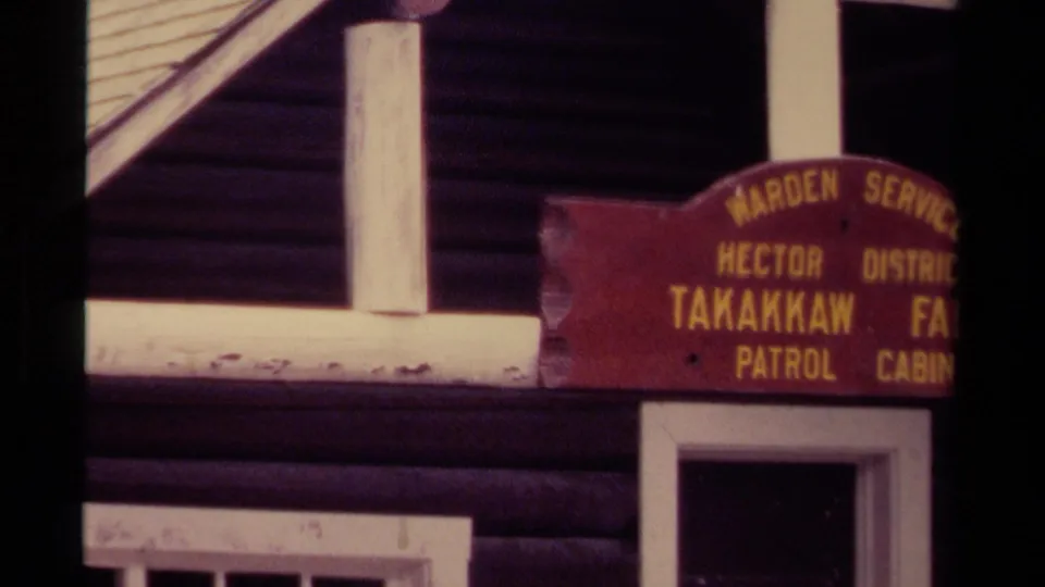1979 Canada 8mm frame with the Takakkaw Falls sign partly cropped as the cabin trim and dark logs become more visible.