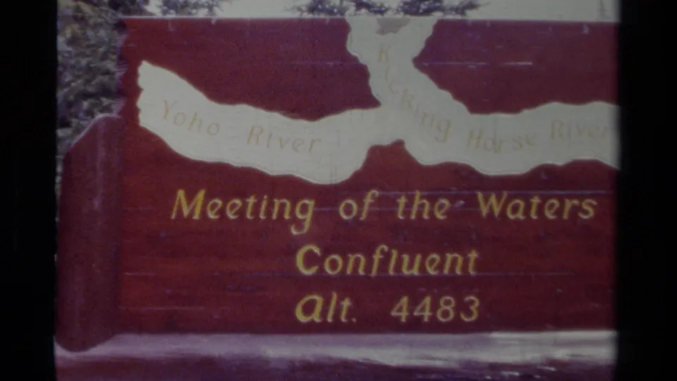 1979 Canada 8mm frame showing the Meeting of the Waters Confluent sign, with Yoho River and Kicking Horse River text partly readable.