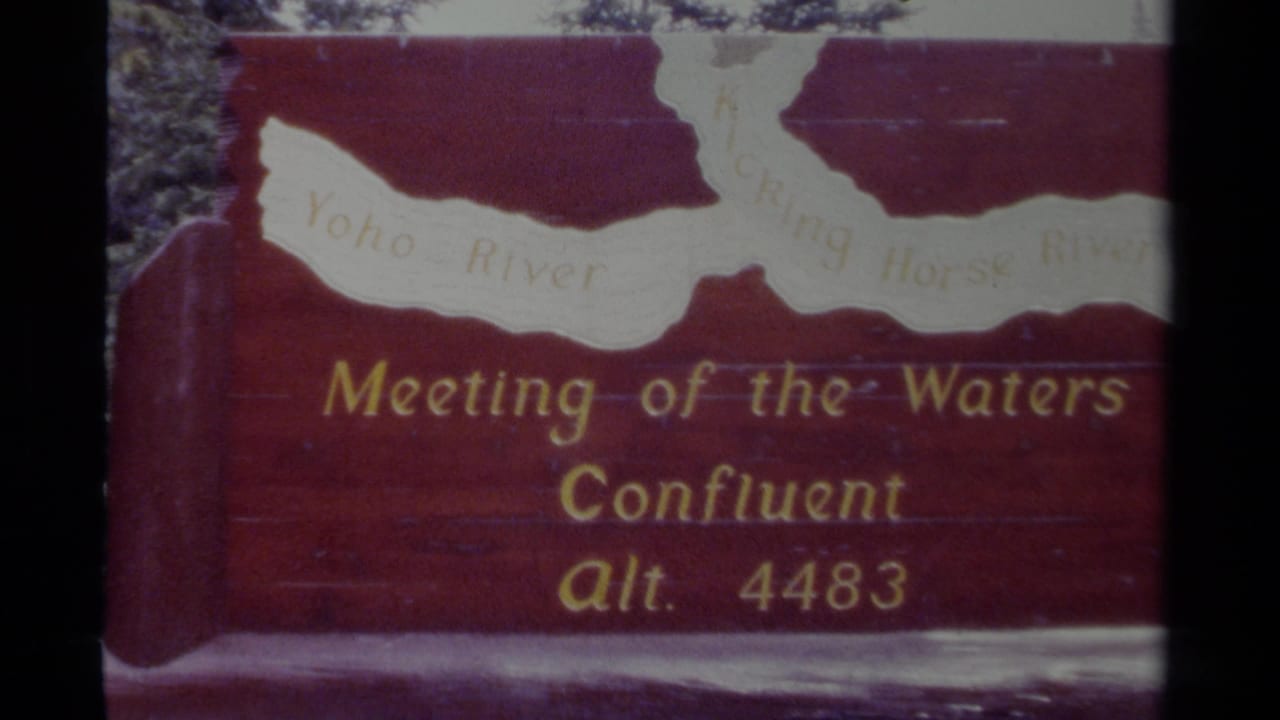 Red wooden Meeting of the Waters sign with river map and altitude text.