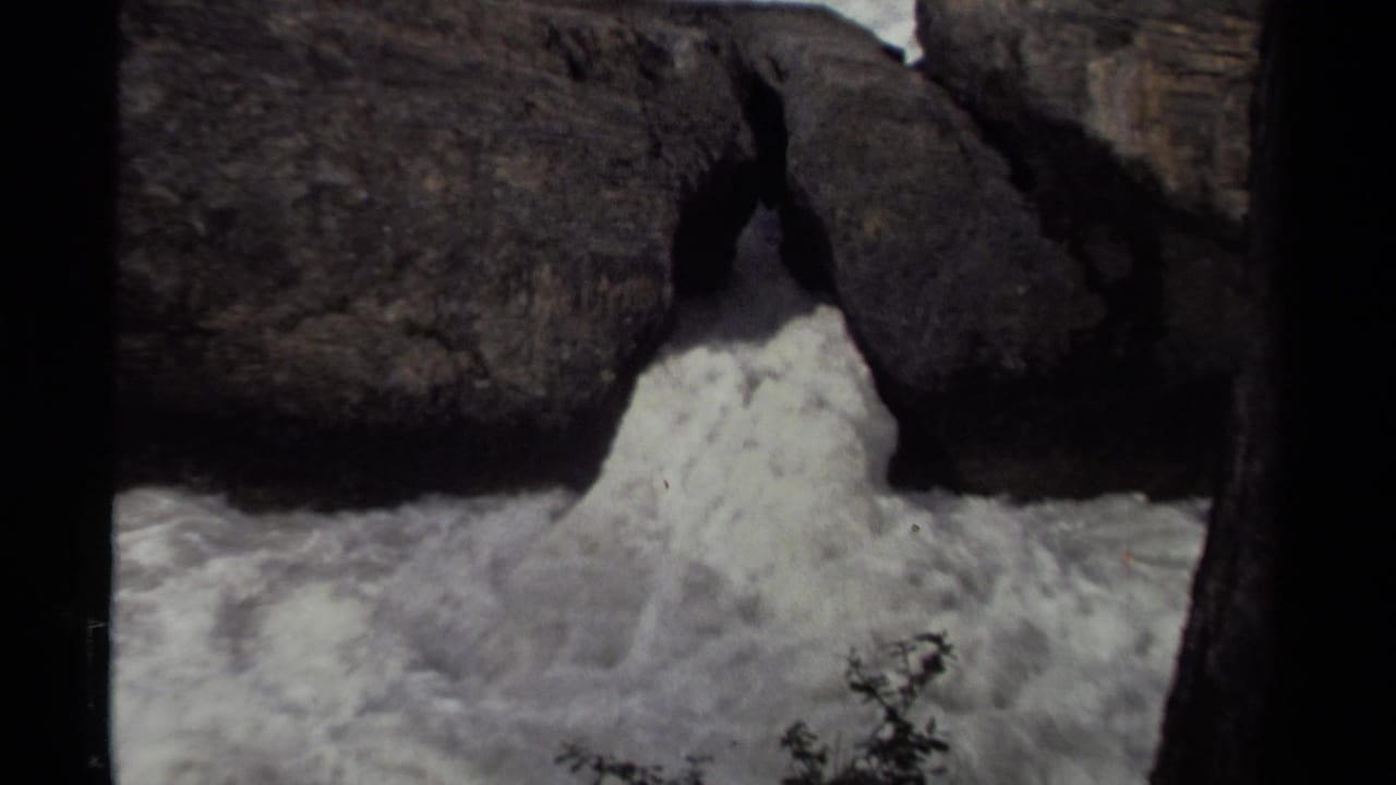 1979 Canadian home-movie still of churning water forced through a rugged rock passage.