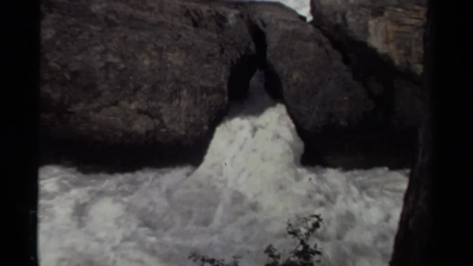 1979 Canadian home-movie still of churning water forced through a rugged rock passage.