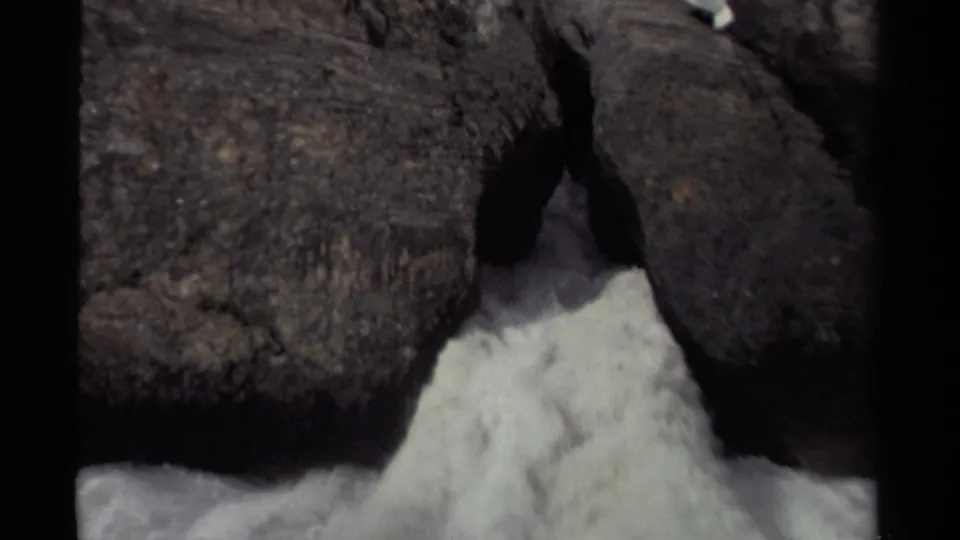 8mm frame from Canada in 1979 showing a close view of white water and heavy rock formations.