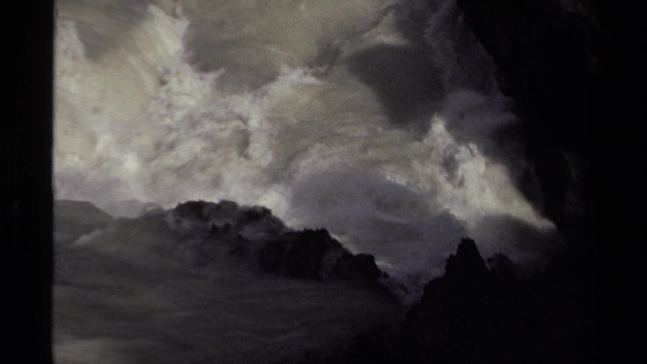 1979 Canada 8mm frame showing storm-swollen water crashing through dark rock formations with thick white spray.