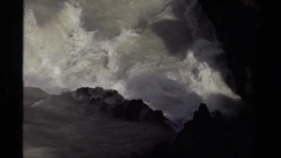 1979 Canada 8mm frame showing storm-swollen water crashing through dark rock formations with thick white spray.