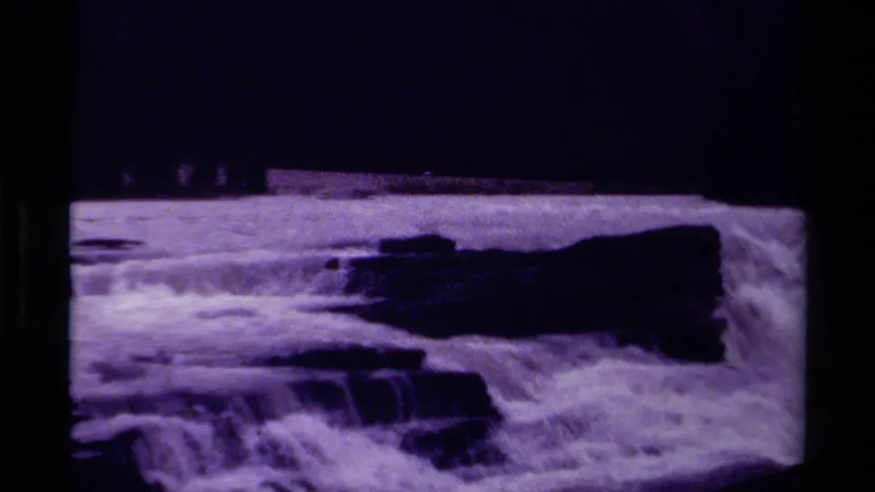 1979 Canada 8mm frame centered on foaming rapids and rock drops below a shadowed mountain backdrop.