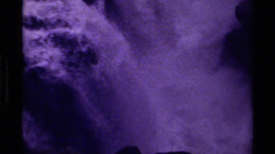 1979 Canadian 8mm frame focused on purple-tinted waterfall spray and rock edges near the end of the short clip.