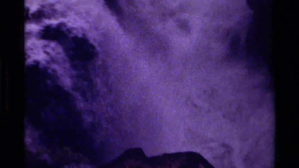 Purple-shifted 8mm frame from Canada showing white water moving through rugged rock formations.