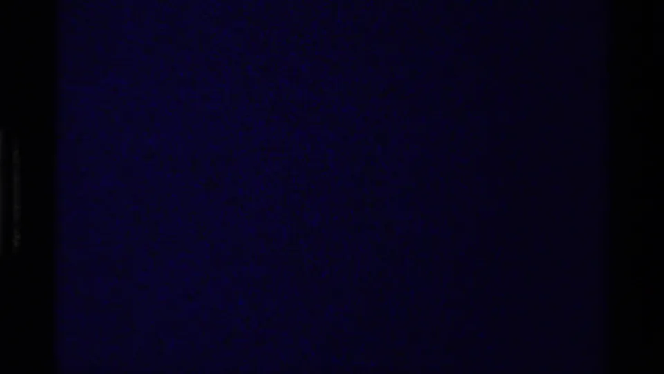 Opening 8mm frame from the 1979 Canada clip, largely dark with a muted blue-purple cast and visible film borders.