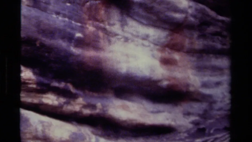 Final contact-sheet frame shows the same indistinct rock or cliff texture, with purple-brown color shifts and visible 8mm grain.