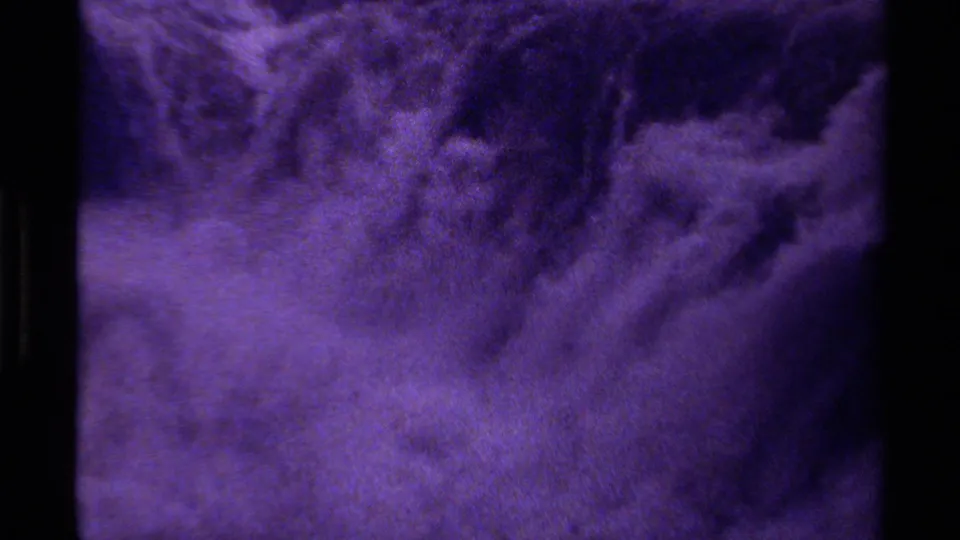 A close waterfall view fills the frame with moving water, spray, and the soft exposure of vintage 8mm footage.