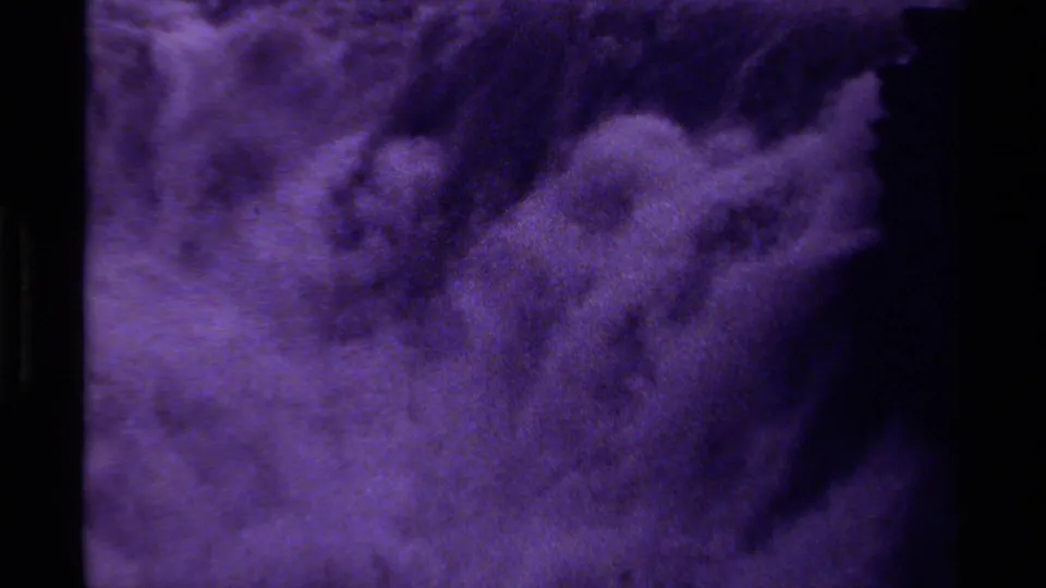 1979 Canadian 8mm frame with purple abstract motion, soft cloudy forms, and dark negative space.