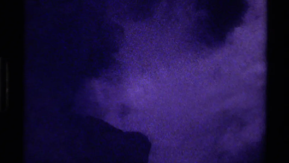 1979 Canada 8mm frame showing a dark central shadow across a purple-blue glacier-like close-up, rendered with soft grain.