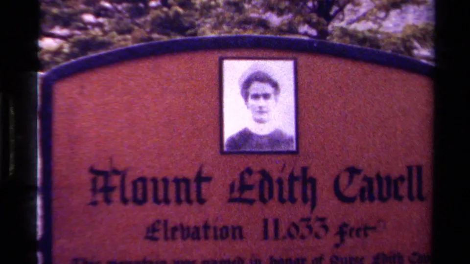 Close view of a Mount Edith Cavell sign in Canada, showing elevation text and a portrait panel above the lettering.