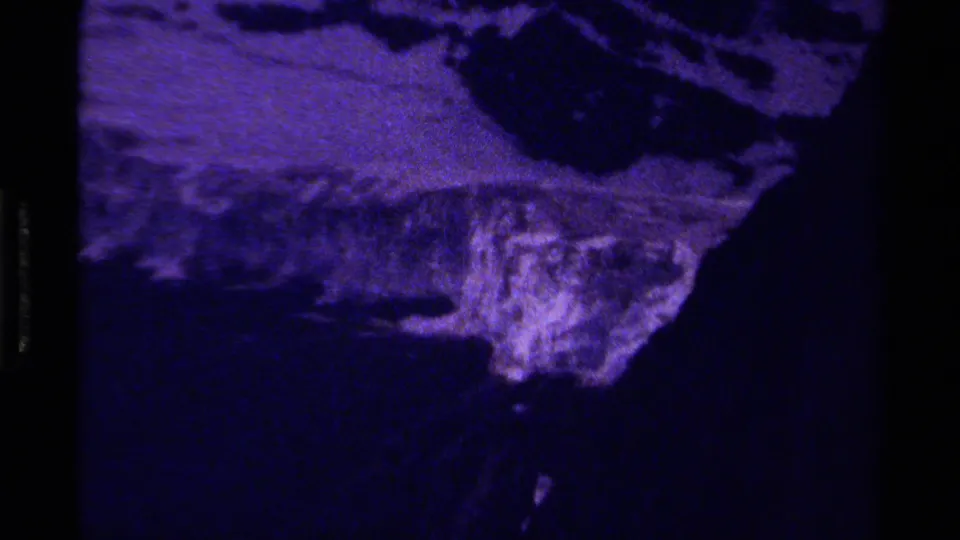 Grainy 1979 Canada mountain view with a purple cast, showing rough slope surfaces and heavy dark exposure.