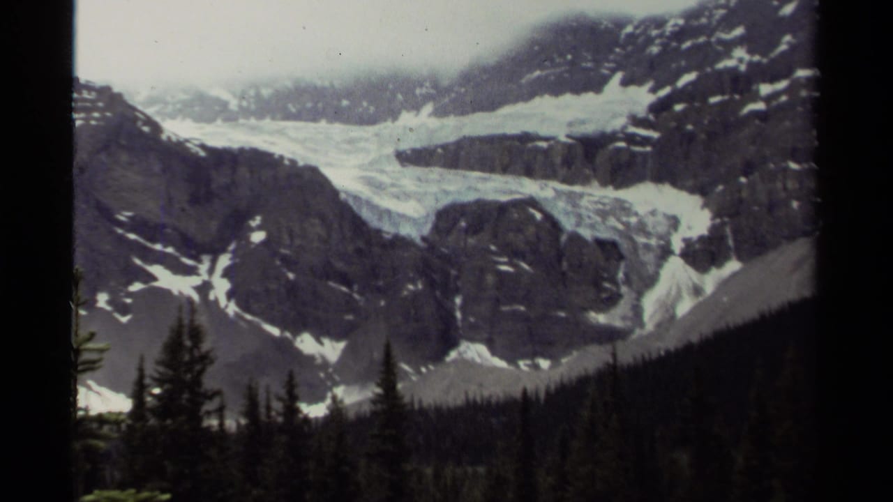 A second 1979 Canada frame holds on the glacier-like snowfield and rocky peaks, bordered by the dark edges of the 8mm scan.