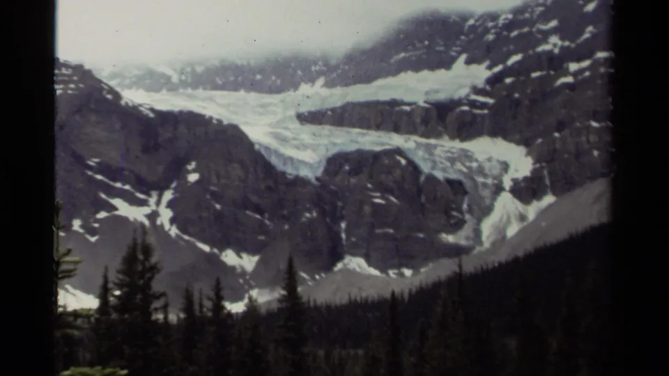 A second 1979 Canada frame holds on the glacier-like snowfield and rocky peaks, bordered by the dark edges of the 8mm scan.