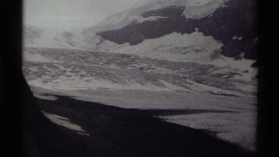 1979 Canada 8mm frame with icy mountain terrain, shadowed rock, and broad snowfield during a slow zoom.
