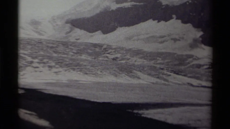 1979 Canada 8mm frame showing a closer view of textured ice, snowfields, and a shadowed mountain face.