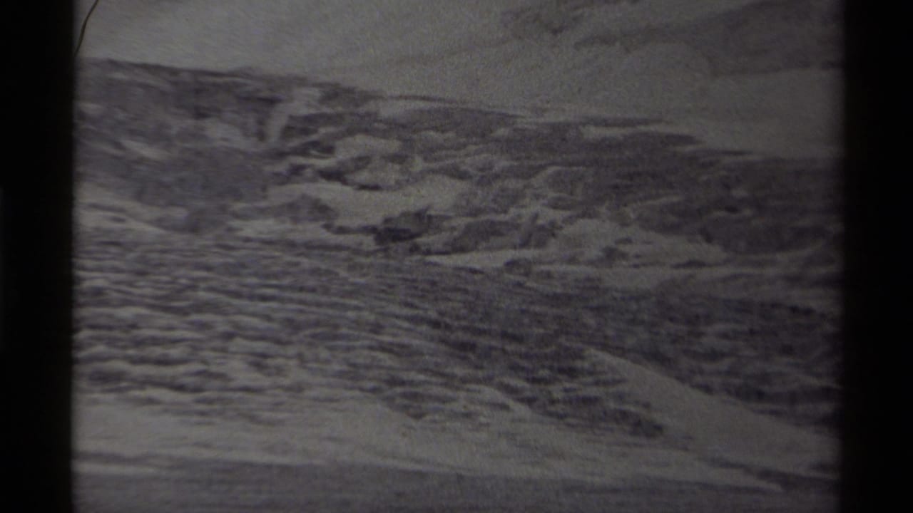 Wide 8mm view of icy Canadian terrain, with layered ridges and snow visible across the distant ground.