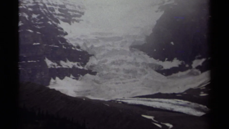 Canadian 1979 home-movie frame with a glacier descending between shadowed mountain slopes.