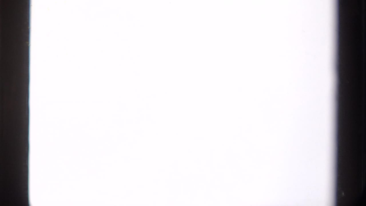 Mostly blank overexposed film frame bordered by dark vertical film edges.