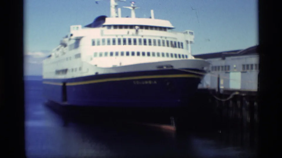 The vessel Columbia is seen from the bow while docked beside an Alaska pier in 1977 home-movie footage.