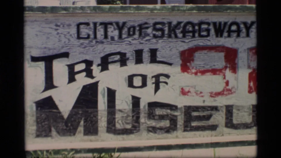 Close view of a weathered City of Skagway Trail of 98 Museum sign, confirming the Skagway, Alaska location context.