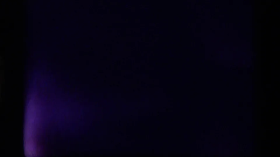 The frame turns mostly dark with a purple tint, suggesting the 8mm camera lens is covered or blocked.