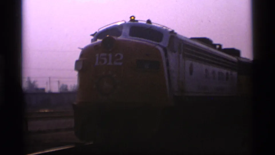The front of locomotive 1512 is seen with cars behind it, in grainy 1977 Alaska home-movie footage.