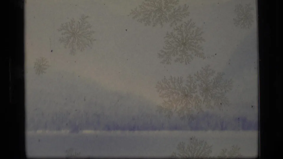 1977 Alaska 8mm close view of frost-like crystals over a hazy mountain and shoreline landscape.