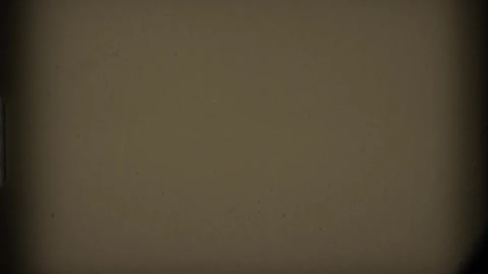 A largely obscured 8mm frame with tan exposure areas, dark borders, and no identifiable person or landscape visible.