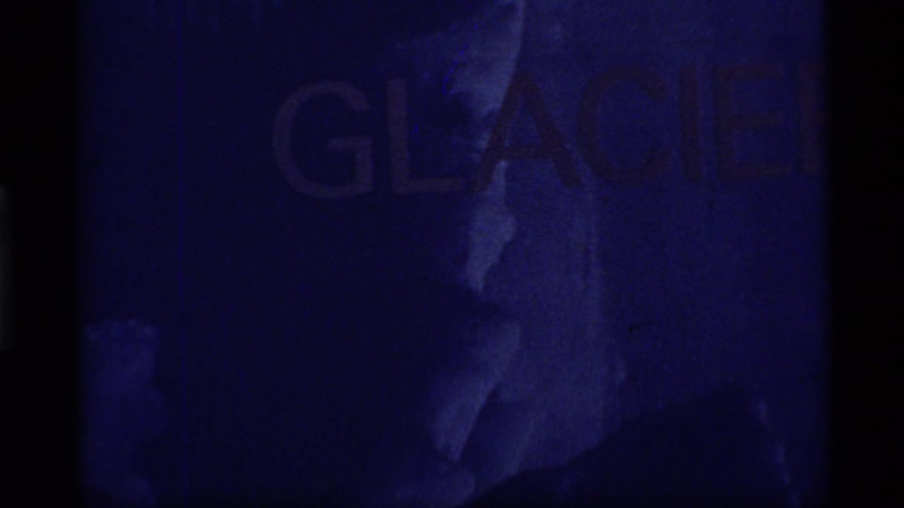 Dark blue film frame with faint large GLACIER lettering and vertical film border.