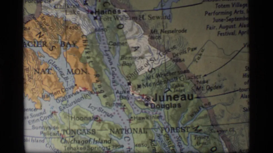 1977 8mm map shot of southeast Alaska, centered on Juneau and Douglas with Glacier Bay area markings nearby.