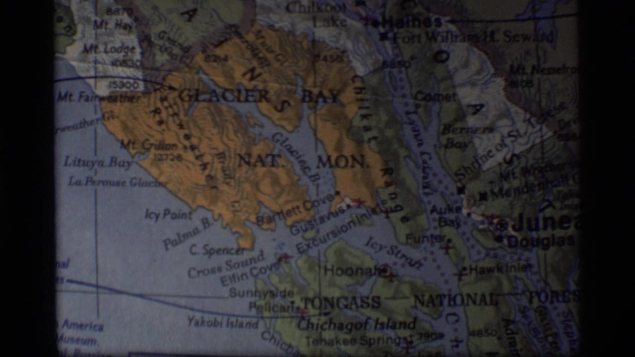 1977 8mm frame of a printed Alaska map centered on Glacier Bay, Tongass National Forest and the Juneau area.