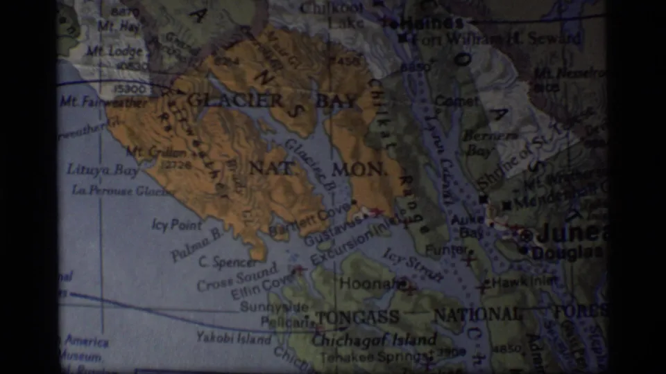 1977 8mm frame of a printed Alaska map centered on Glacier Bay, Tongass National Forest and the Juneau area.