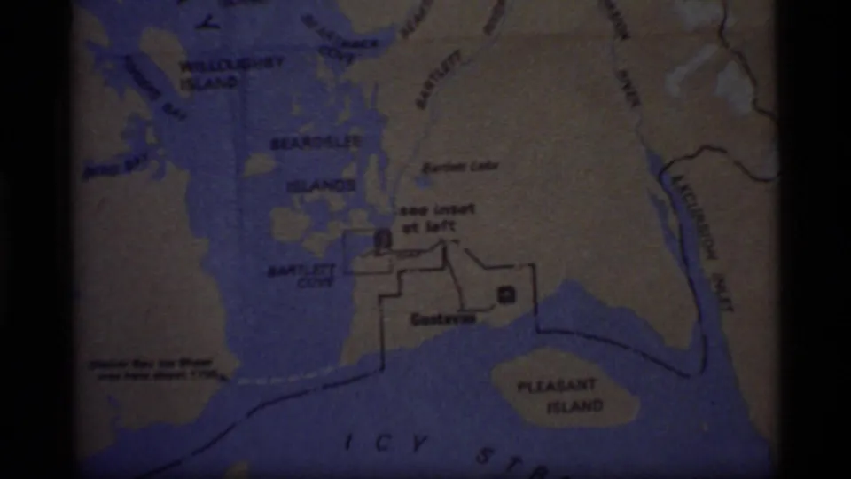 8mm frame of a printed Glacier Bay area map with Bartlett Cove, Pleasant Island, and nearby islands visible.