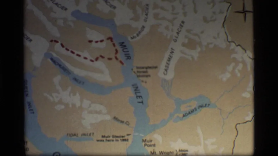 1977 8mm frame of a Glacier Bay map section showing Muir Inlet, Casement Glacier, Muir Glacier area labels and Adams Inlet.
