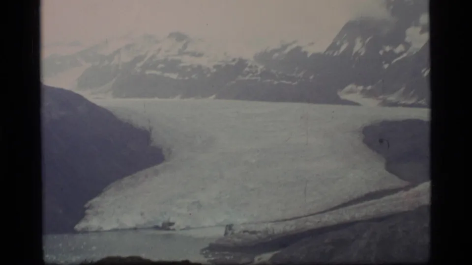 Glacier Bay, Alaska, seen in 1977 8mm footage with glacial ice, surrounding mountains, and muted blue-gray water.