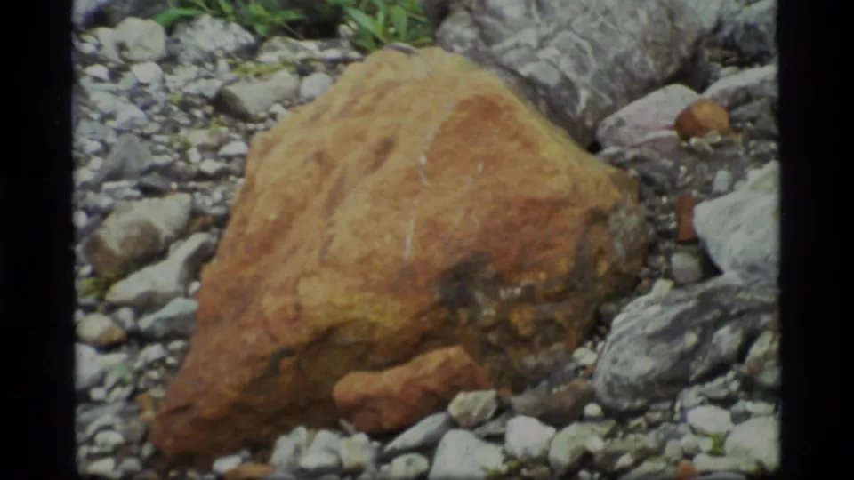 1977 Glacier Bay 8mm close-up with the brown rock filling the foreground amid gray stones and gravel.