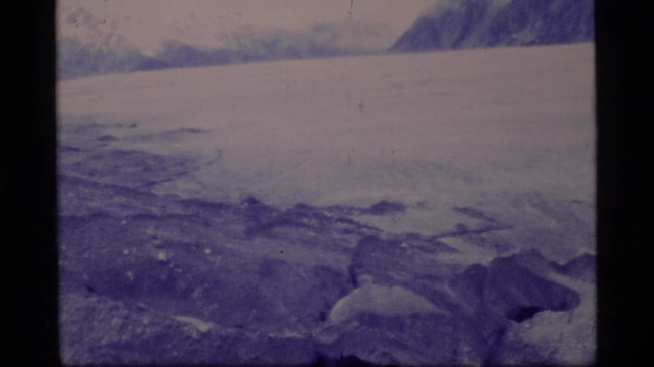 Glacier Bay home-movie view of rough icy terrain and distant mountains, with no people visible in this frame.