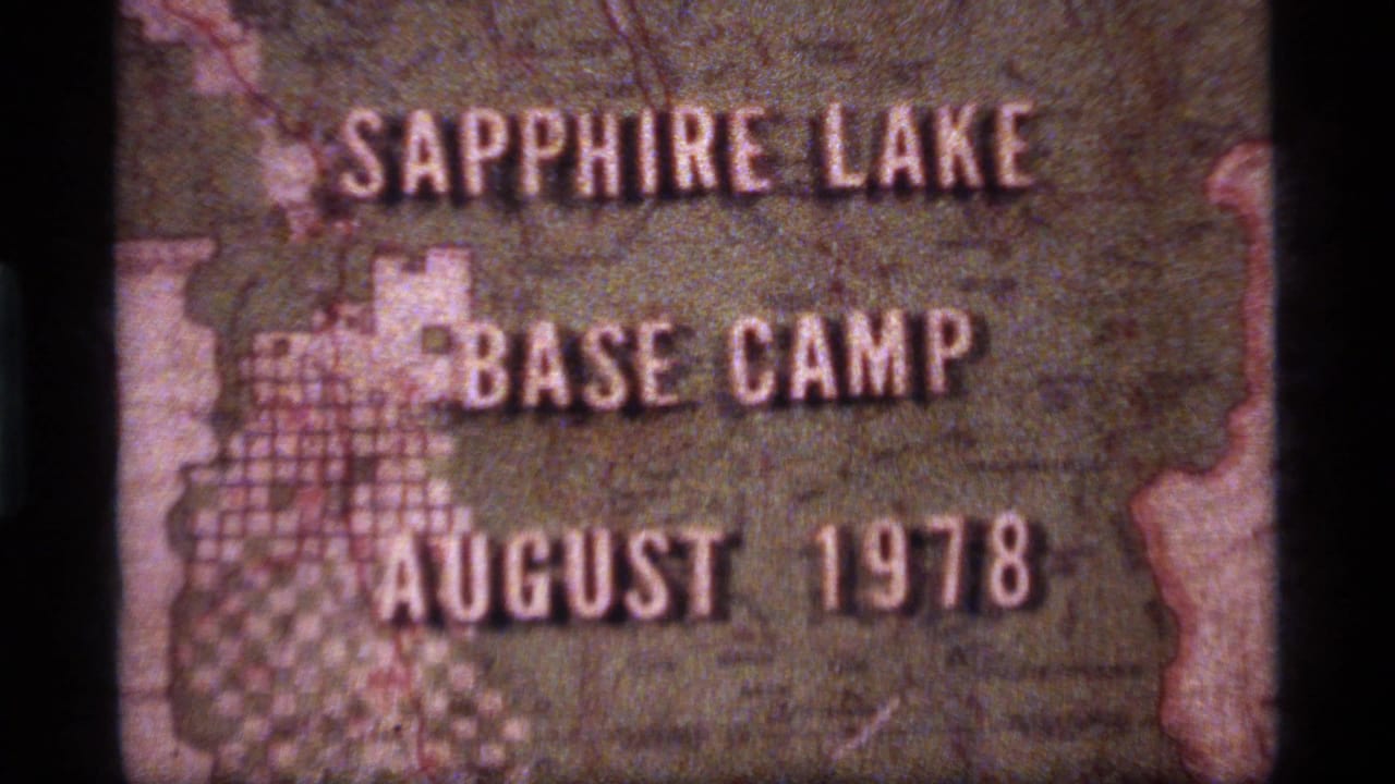 1970s 8mm title card for Sapphire Lake Base Camp in Montana, with August 1978 lettering over a textured map-like background.