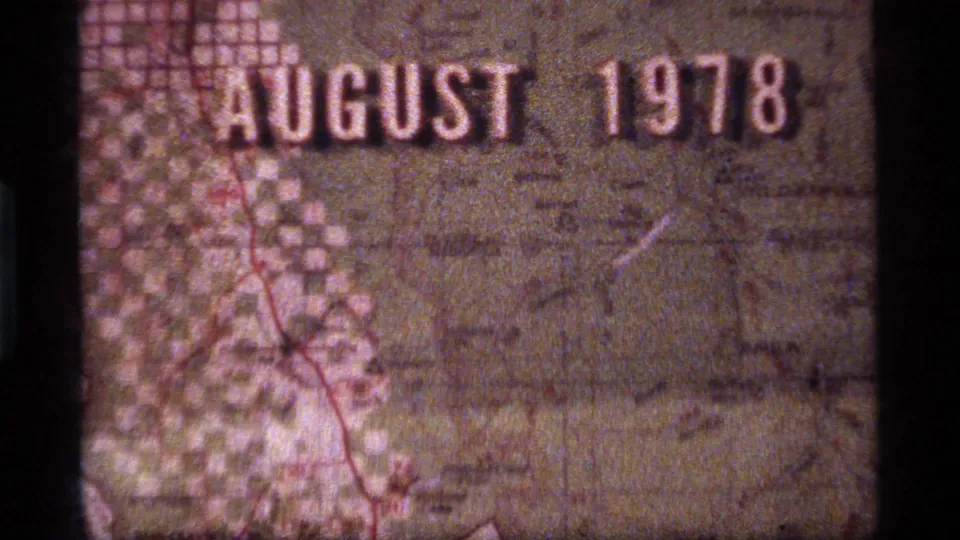 8mm home-movie frame of a Montana-area map with "AUGUST 1978" title text, red route marking, and visible film wear.