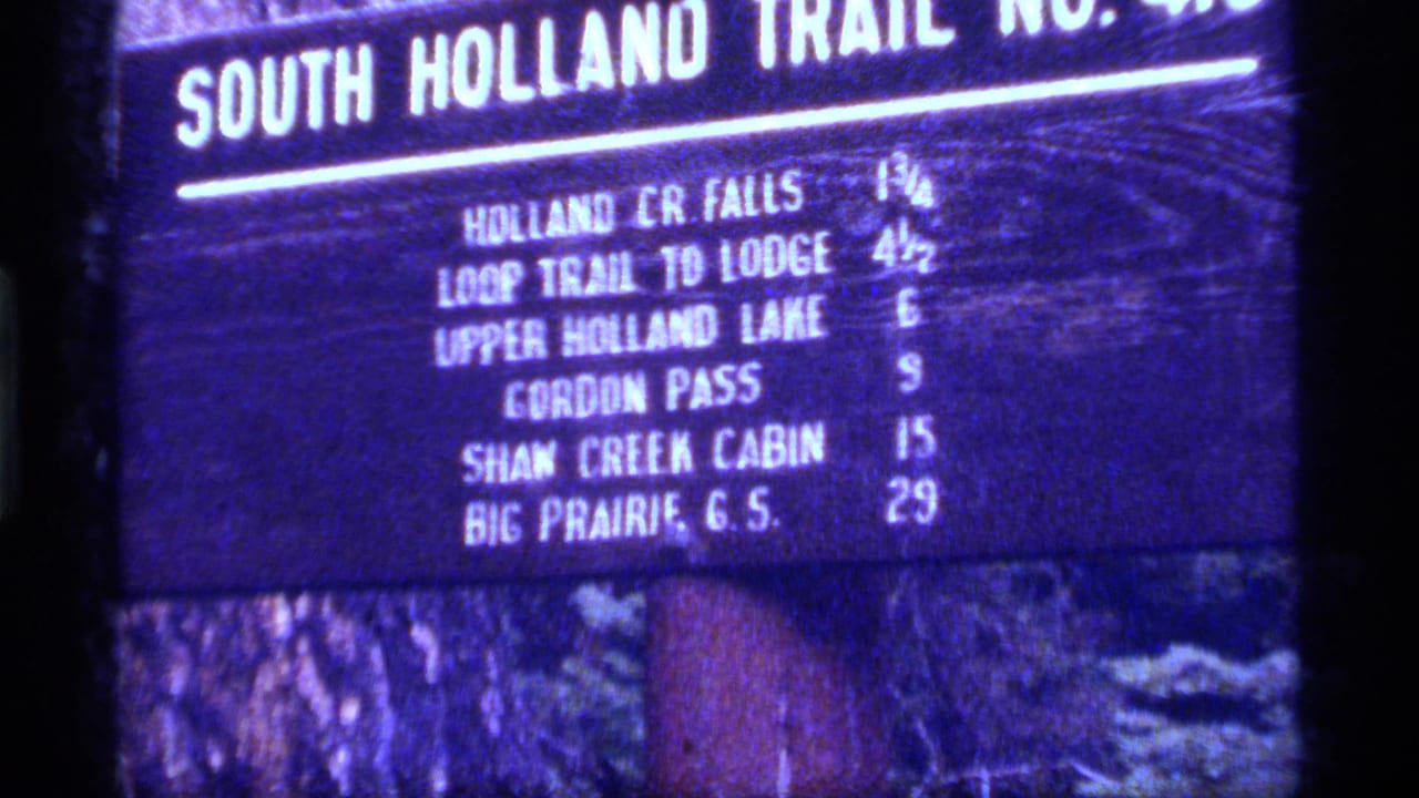 Close 1977 8mm view of the South Holland Trail sign, with Upper Holland Lake and other destinations listed.