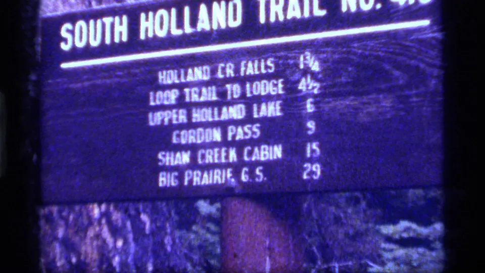 Close 1977 8mm view of the South Holland Trail sign, with Upper Holland Lake and other destinations listed.