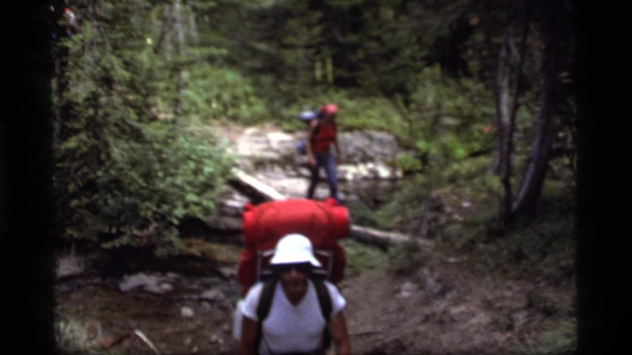A Sapphire Lake trail scene shows a backpacker approaching the camera and another hiker balancing on a log in the forest.
