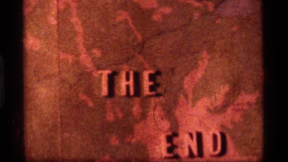1977 8mm end-title frame from Sapphire Lake, Montana with THE END over a red-tinted topographical map.