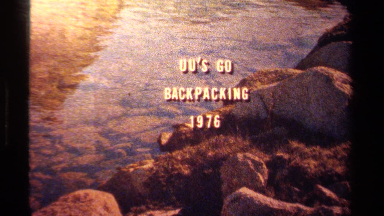 Lake Tahoe home-movie frame with "UU'S GO BACKPACKING 1976" over warm water, rocks, and dark film edges.