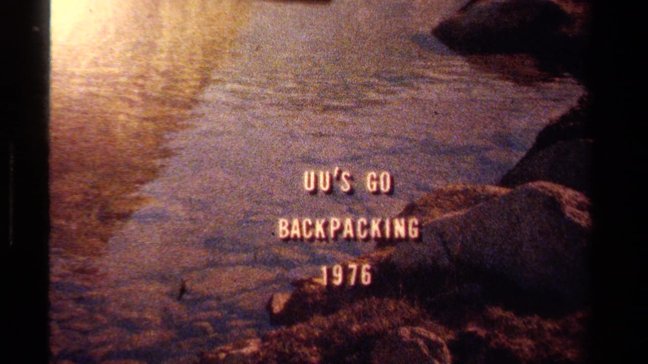 1970s Lake Tahoe frame showing the backpacking title over softly focused water, rocks, and warm reflected light.