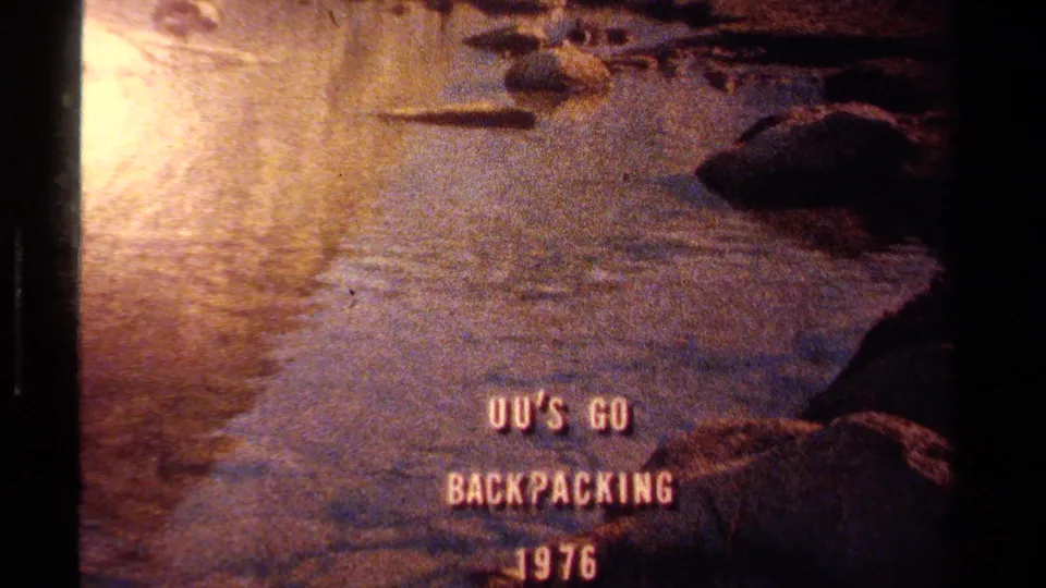 Lake Tahoe 8mm frame with title text over a slow pan across water, rocks, and muted grass near the shore.